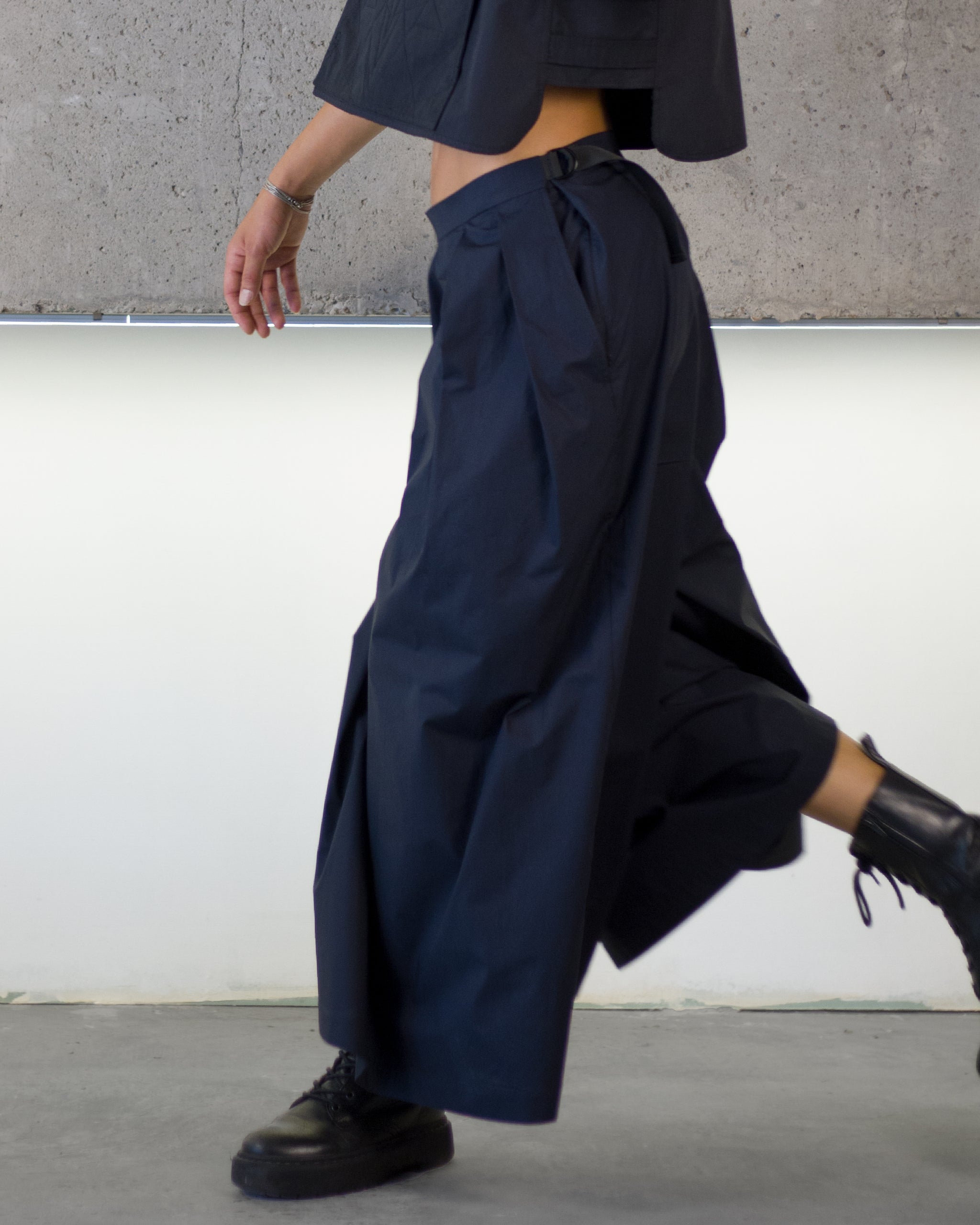 Person wearing dark blue wide-leg pants 